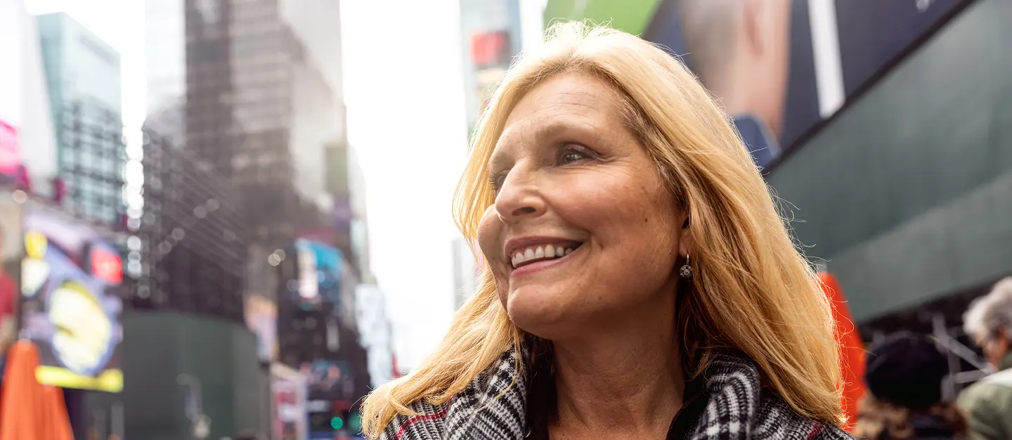 Smiling woman enjoying clear vision in Times Square, New York City