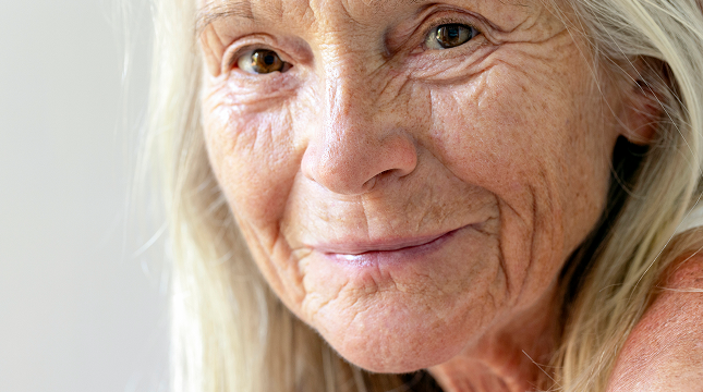 Close-up portrait of a smiling senior woman with healthy eyes